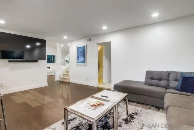 a bedroom with a bed and a lamp on dresser