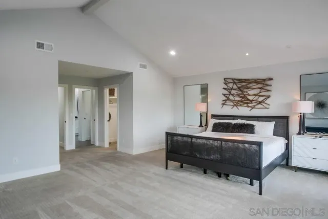 a view of a patio with couches table and chairs with wooden floor and fence