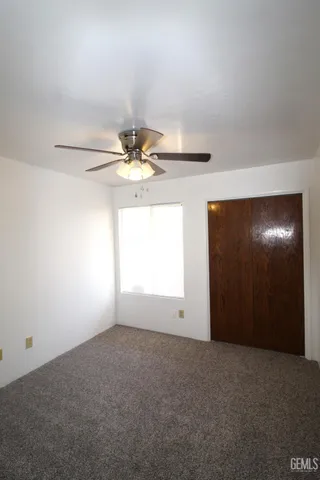 a view of a livingroom with a chandelier fan
