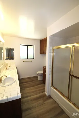 a bathroom with a sink toilet and shower
