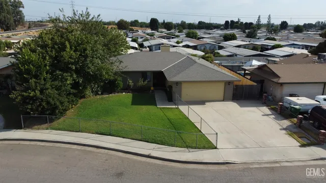 a aerial view of a house with a yard and garage
