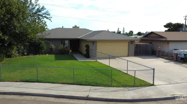 a view of a house with a yard and potted plants