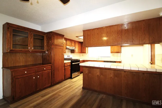a kitchen with stainless steel appliances granite countertop a stove and a refrigerator
