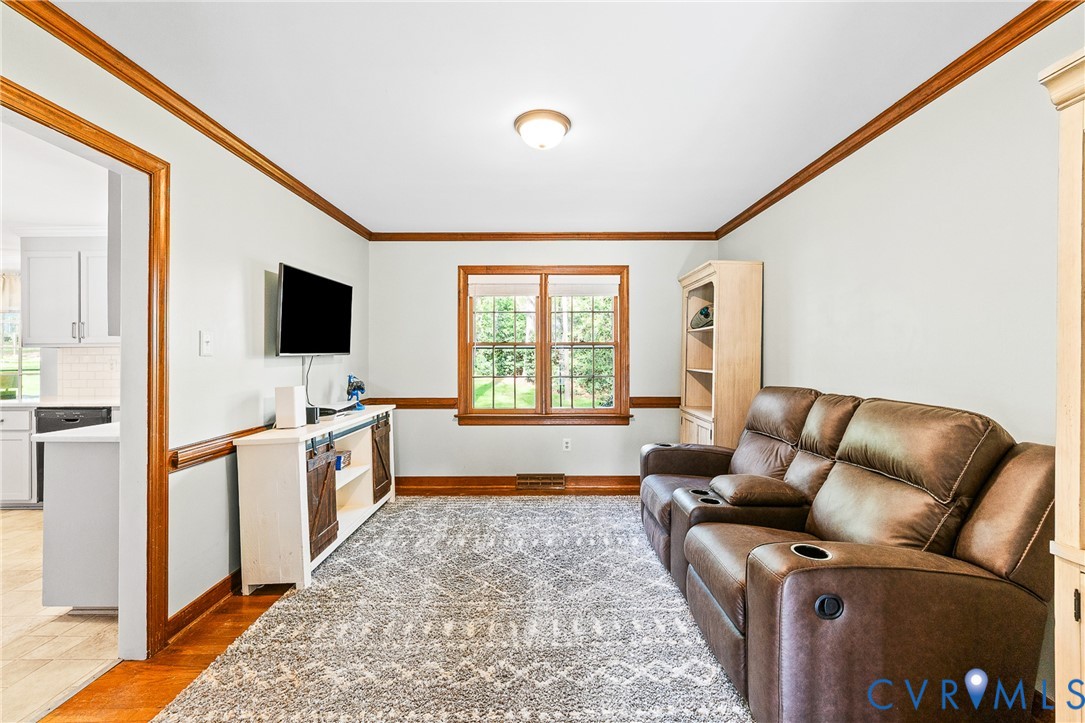 1013 Castle Hollow Road Midlothian, VA 23114 - Photo 19 of 45 Living area with ornamental molding and light wood