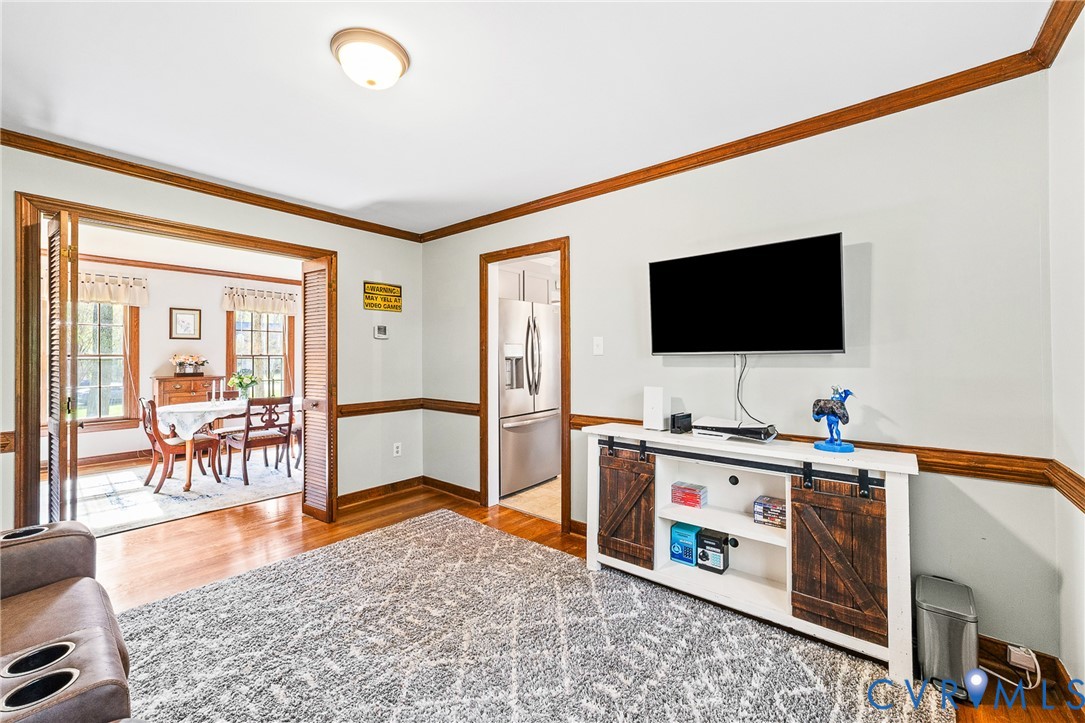 1013 Castle Hollow Road Midlothian, VA 23114 - Photo 20 of 45 Living room with ornamental molding and light wood