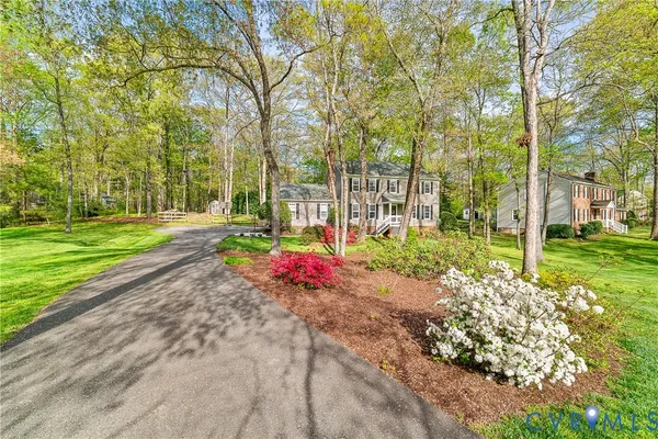 a kitchen with stainless steel appliances granite countertop a stove a sink dishwasher and white cabinets with wooden floor