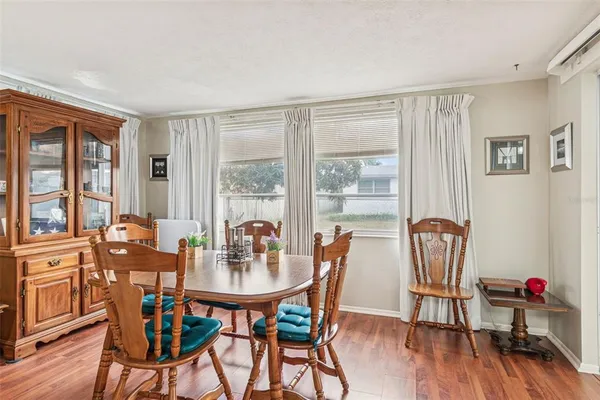 a view of a dining room with furniture and wooden floor