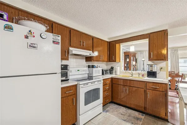 a white refrigerator freezer sitting inside of a kitchen