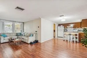 a living room with furniture and a wooden floor