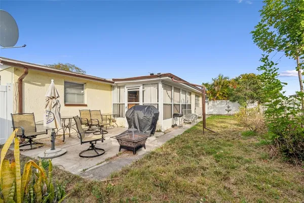 a view of a house with backyard patio and sitting area