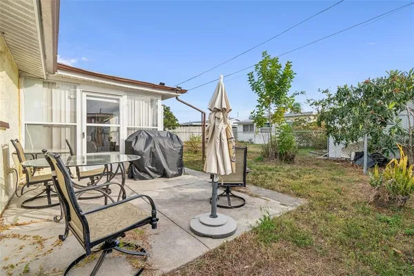 a view of a backyard with furniture and plants