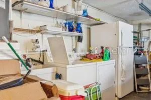 a view of living room with furniture and refrigerator