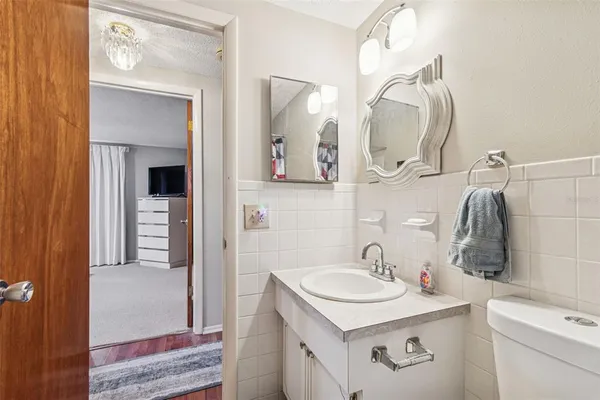 a bathroom with a sink vanity and mirror
