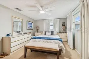 a bed room with a bed and a large mirror