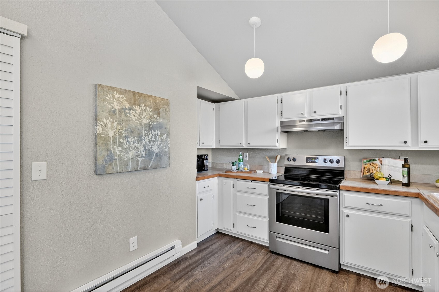 2422 McGregor Road Southeast Port Orchard, WA 98366 - Photo 12 of 32 a kitchen with cabinets stainless steel appliances and wooden floor