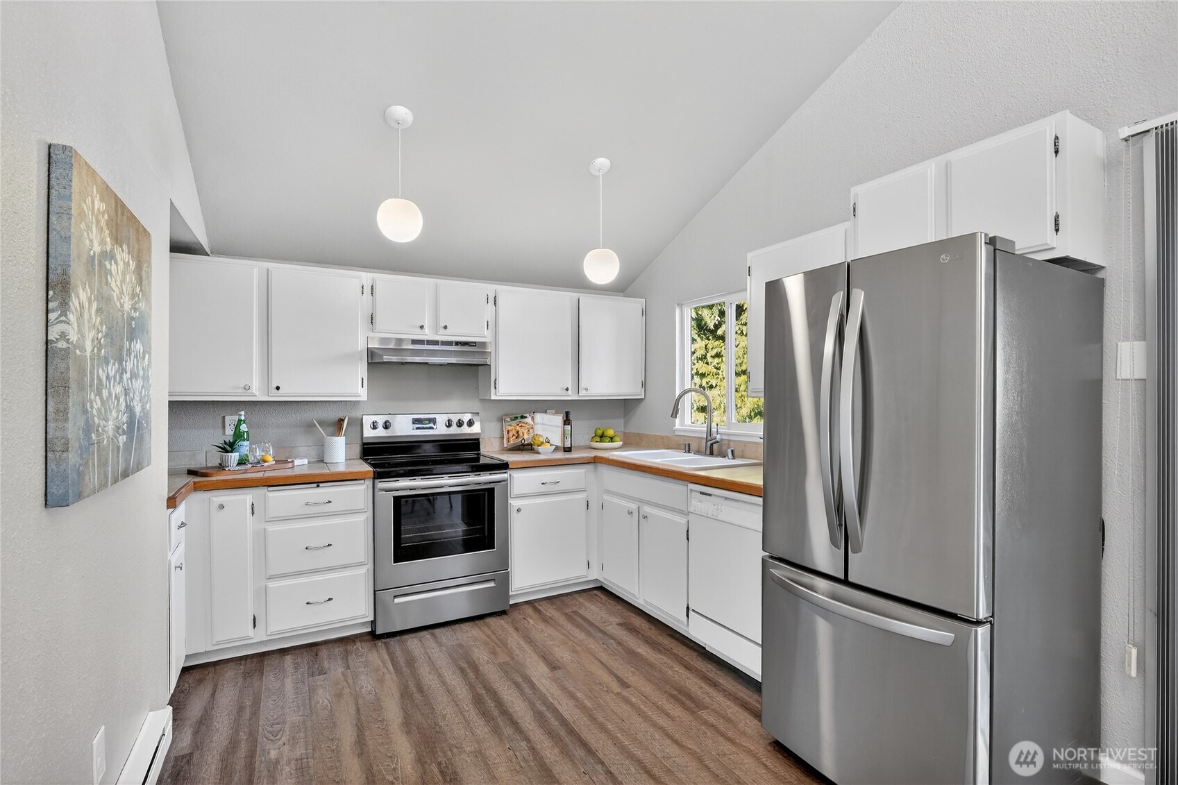 2422 McGregor Road Southeast Port Orchard, WA 98366 - Photo 8 of 32 a kitchen with stainless steel appliances a refrigerator sink and cabinets
