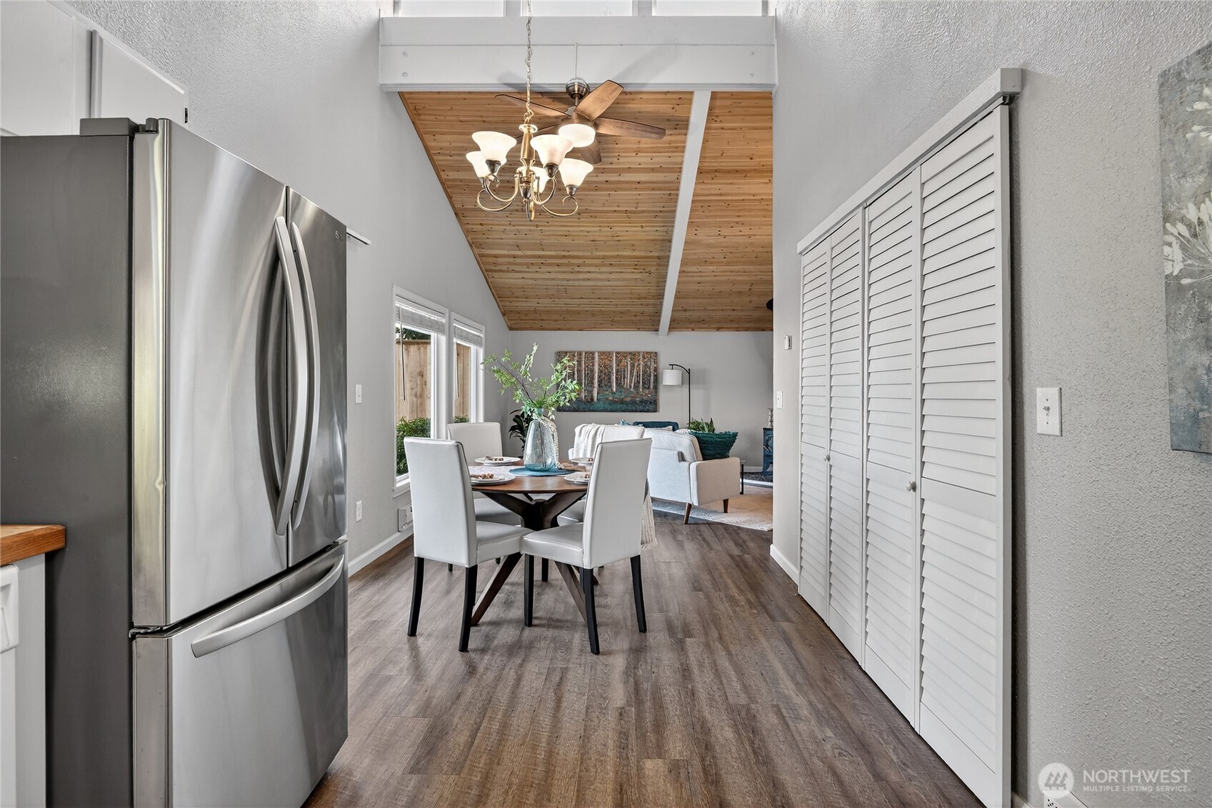 2422 McGregor Road Southeast Port Orchard, WA 98366 - Photo 10 of 32 a kitchen with stainless steel appliances granite countertop a refrigerator and a wooden floor