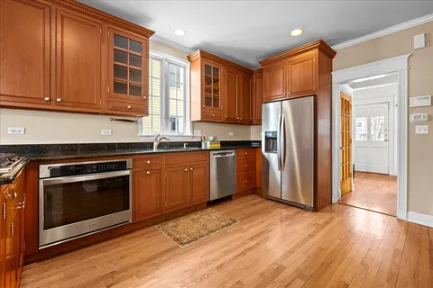 a kitchen with stainless steel appliances granite countertop a stove and a refrigerator