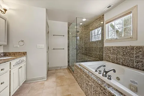 a utility room with cabinets washer and dryer
