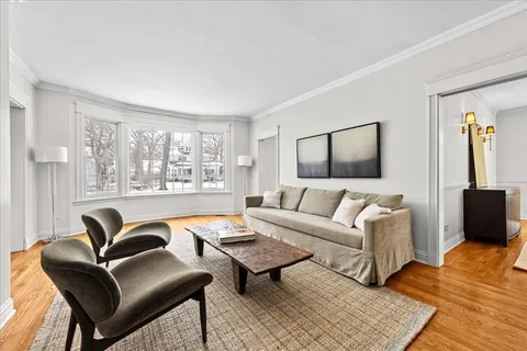 a living room with furniture a rug and a window