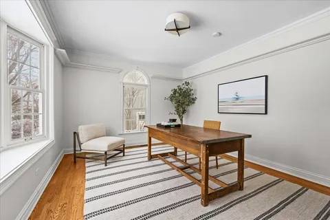 a view of a dining room with furniture window and wooden floor