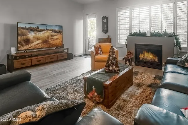 a living room with furniture flat screen tv and a fireplace