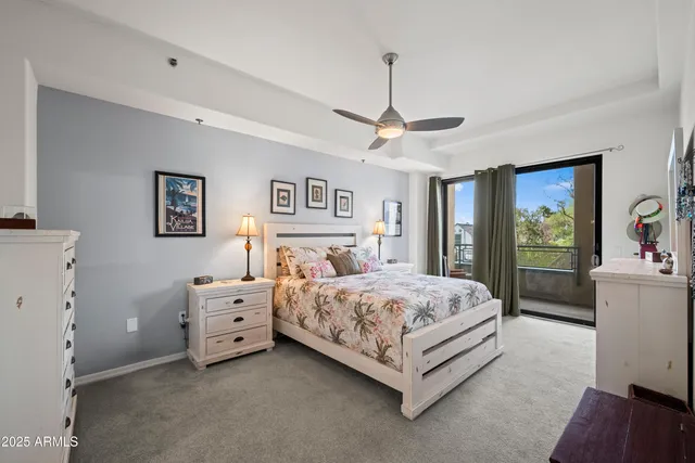 a bedroom with a large bed and a chandelier