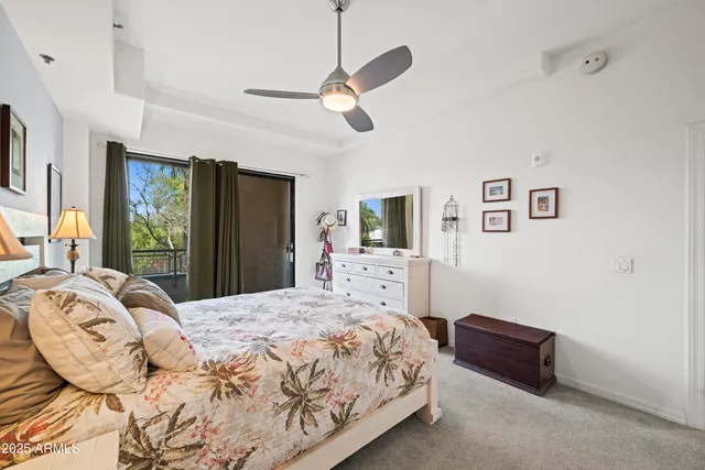 a spacious bedroom with a bed and a large mirror
