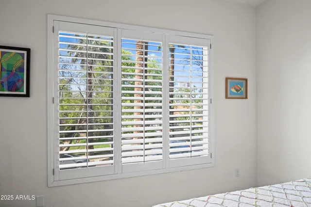 a view of a chairs and table in the back yard