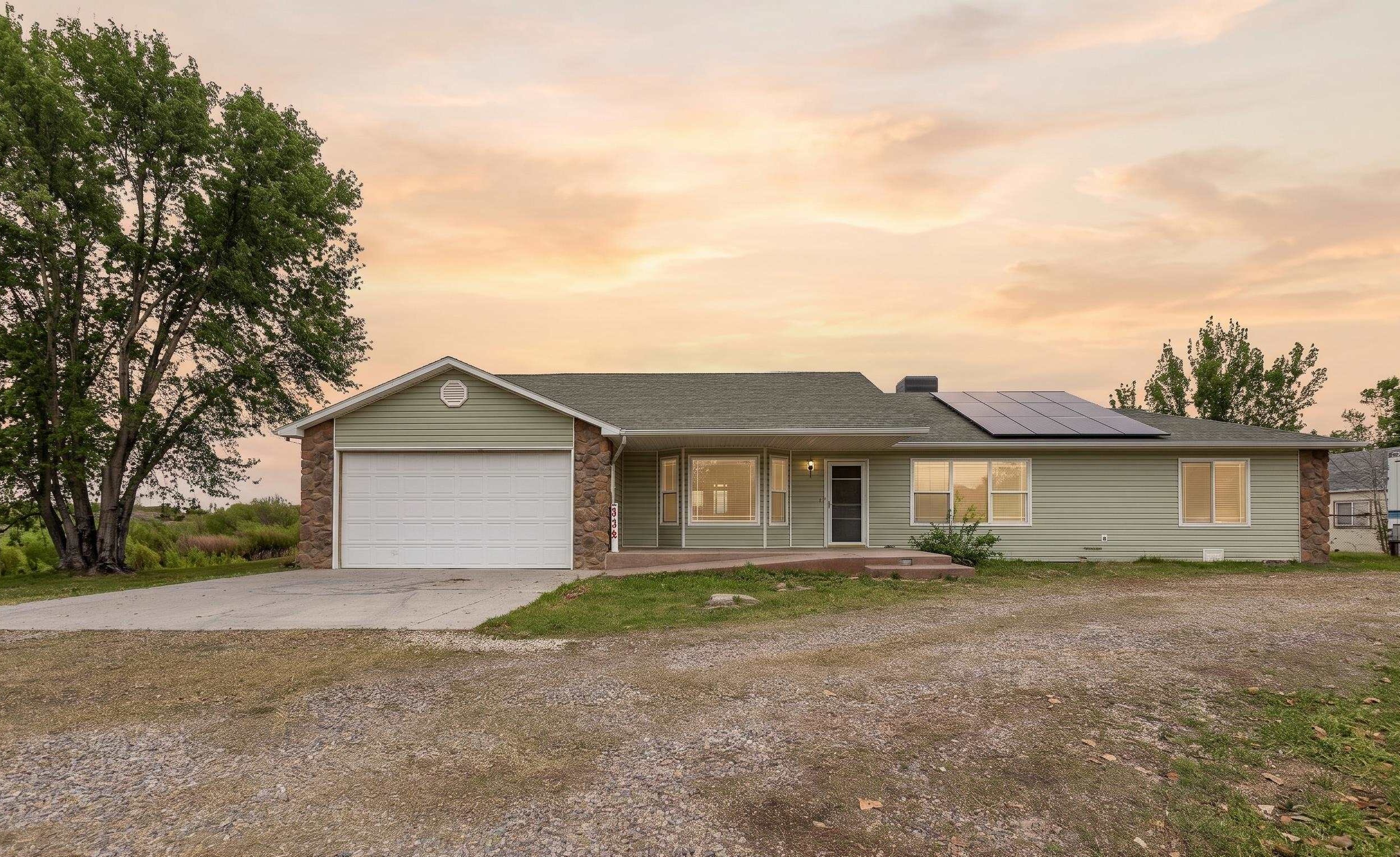2098 J Road Fruita, CO 81521 - Photo 1 of 13 a front view of a house with a yard and garage