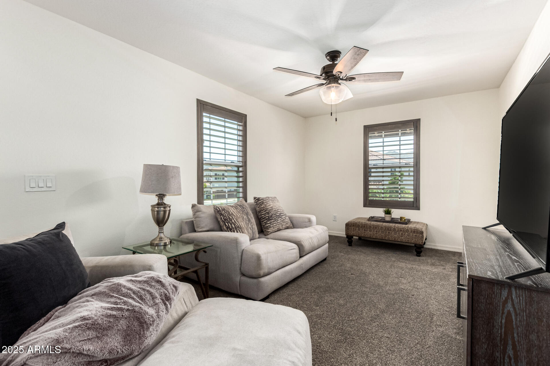 820 Constance Way Phoenix, AZ 85042 - Photo 11 of 29 a living room with furniture and a flat screen tv