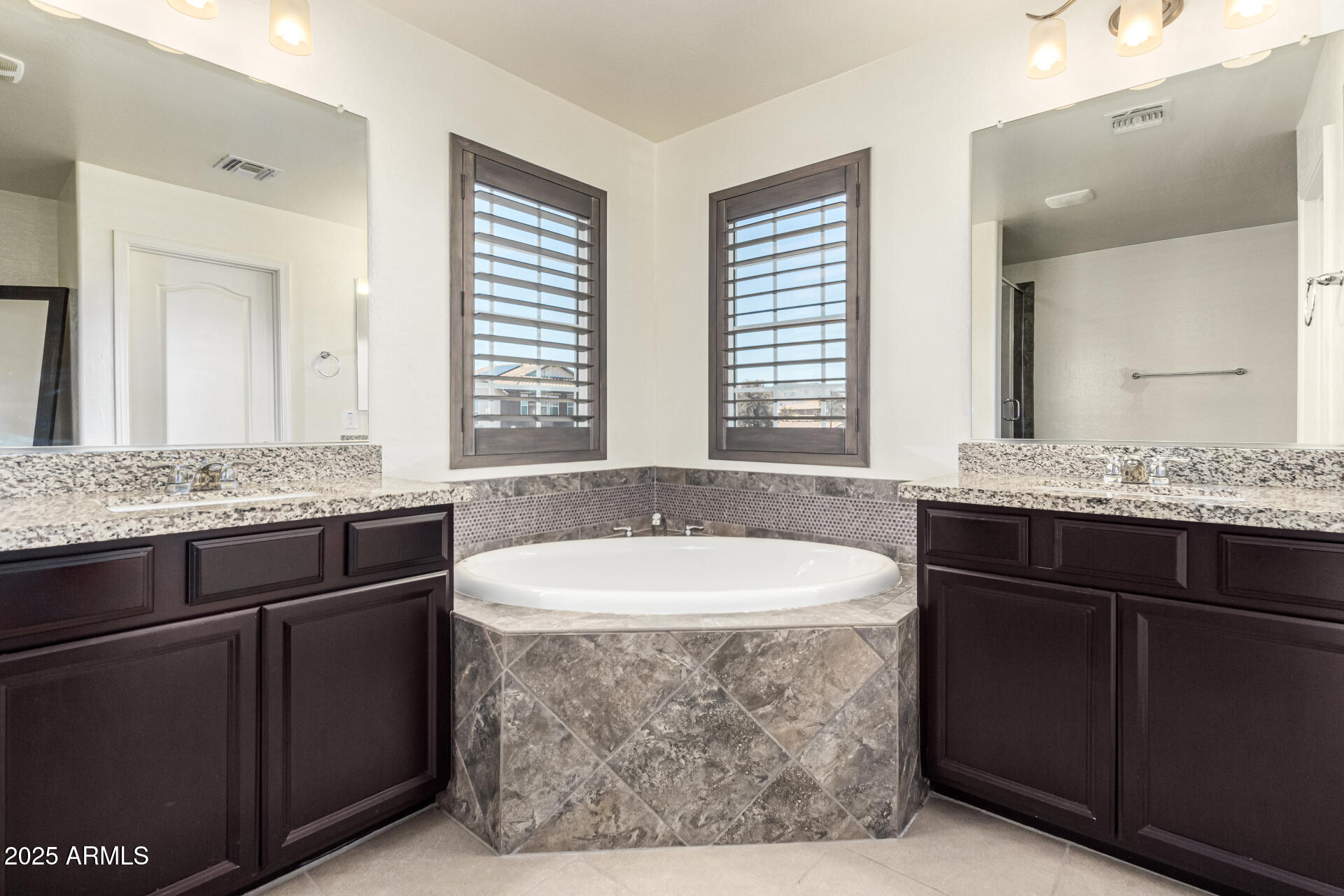 820 Constance Way Phoenix, AZ 85042 - Photo 13 of 29 a bathroom with a granite countertop bathtub sink and mirror