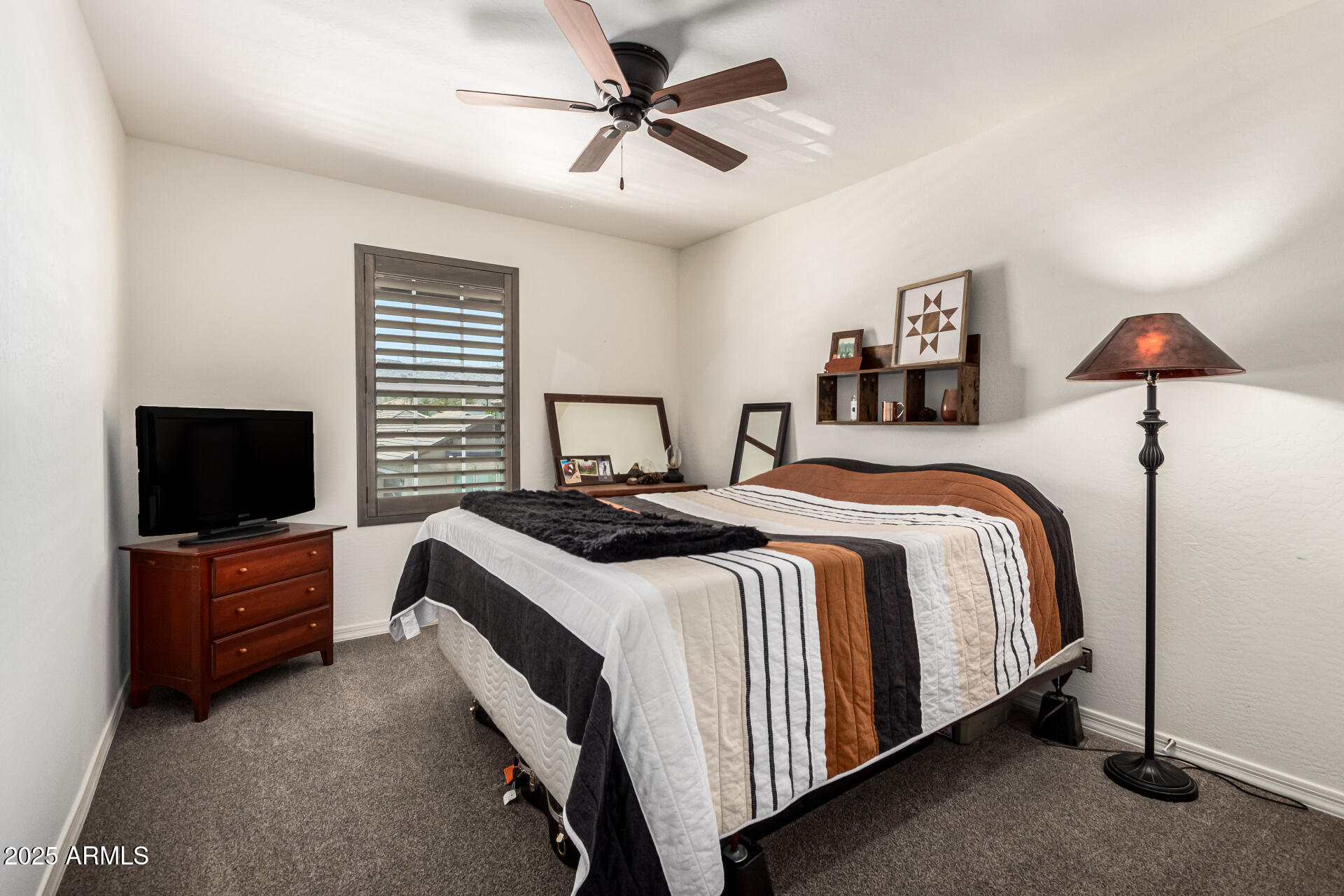 820 Constance Way Phoenix, AZ 85042 - Photo 15 of 29 a bedroom with a bed and a flat screen tv