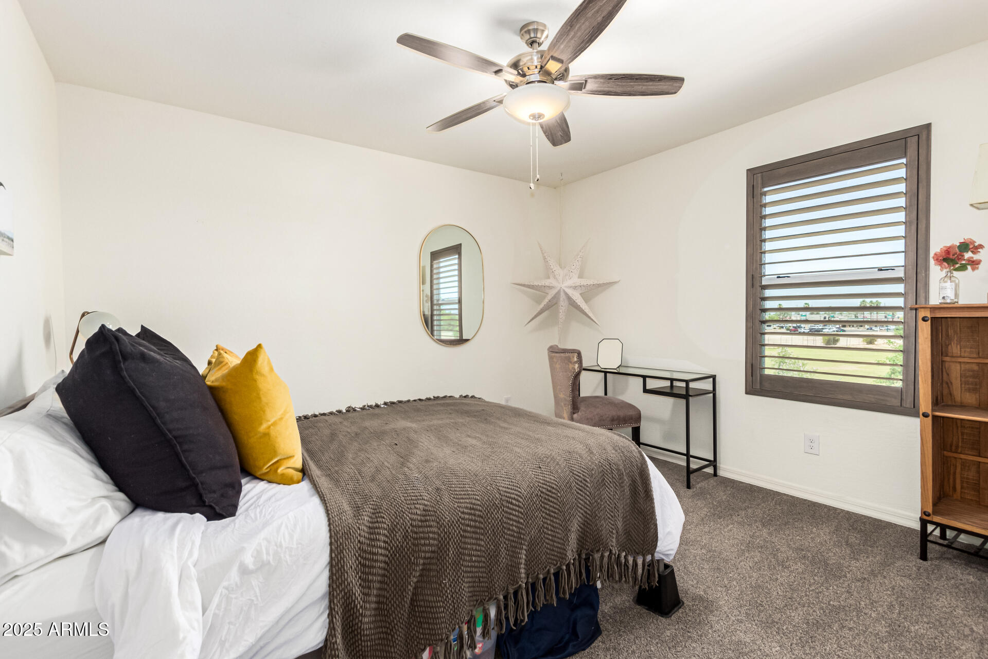 820 Constance Way Phoenix, AZ 85042 - Photo 16 of 29 a bedroom with a bed and a chandelier