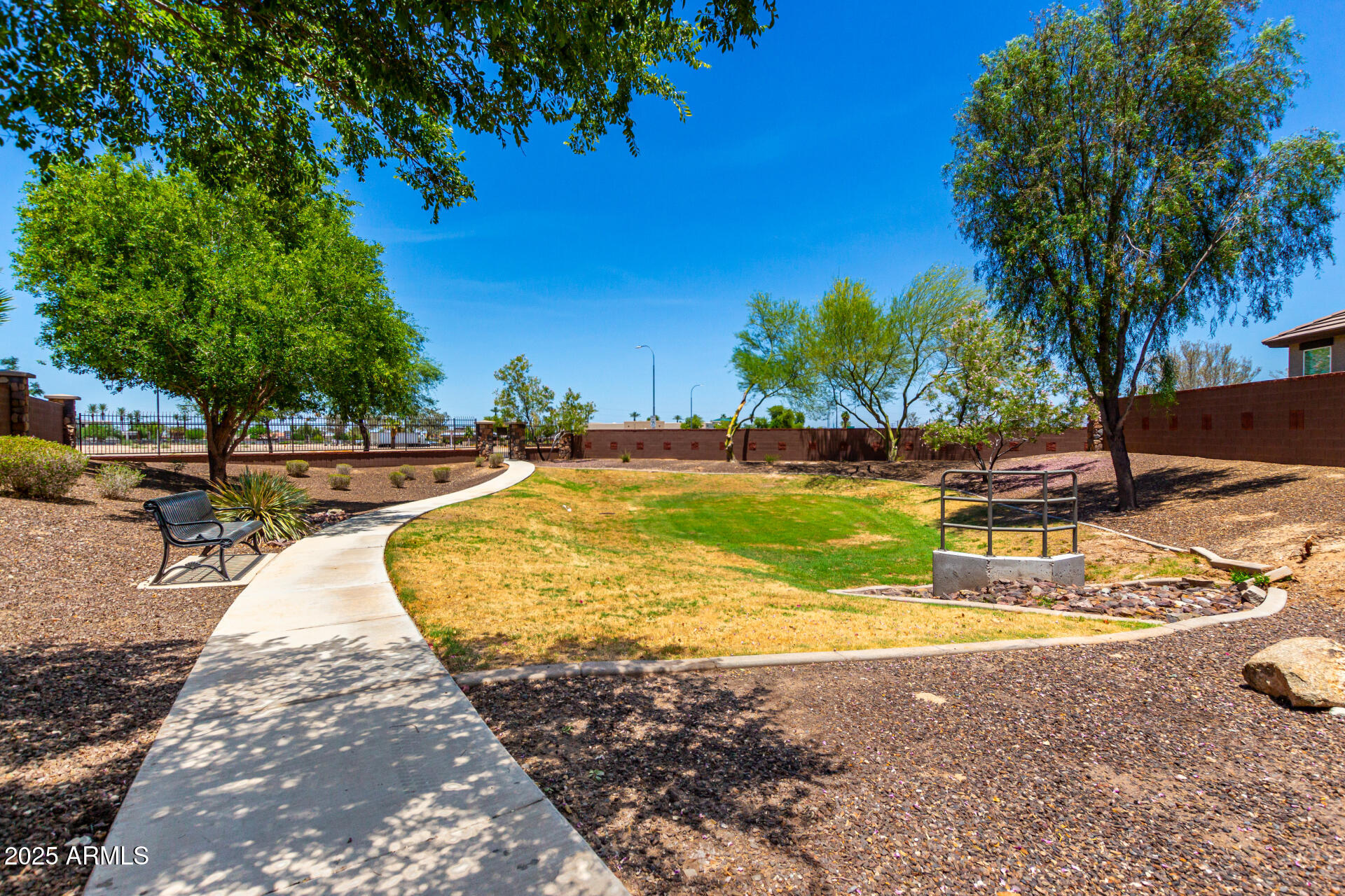 820 Constance Way Phoenix, AZ 85042 - Photo 25 of 29 a view of a swimming pool with a lawn chairs under palm trees