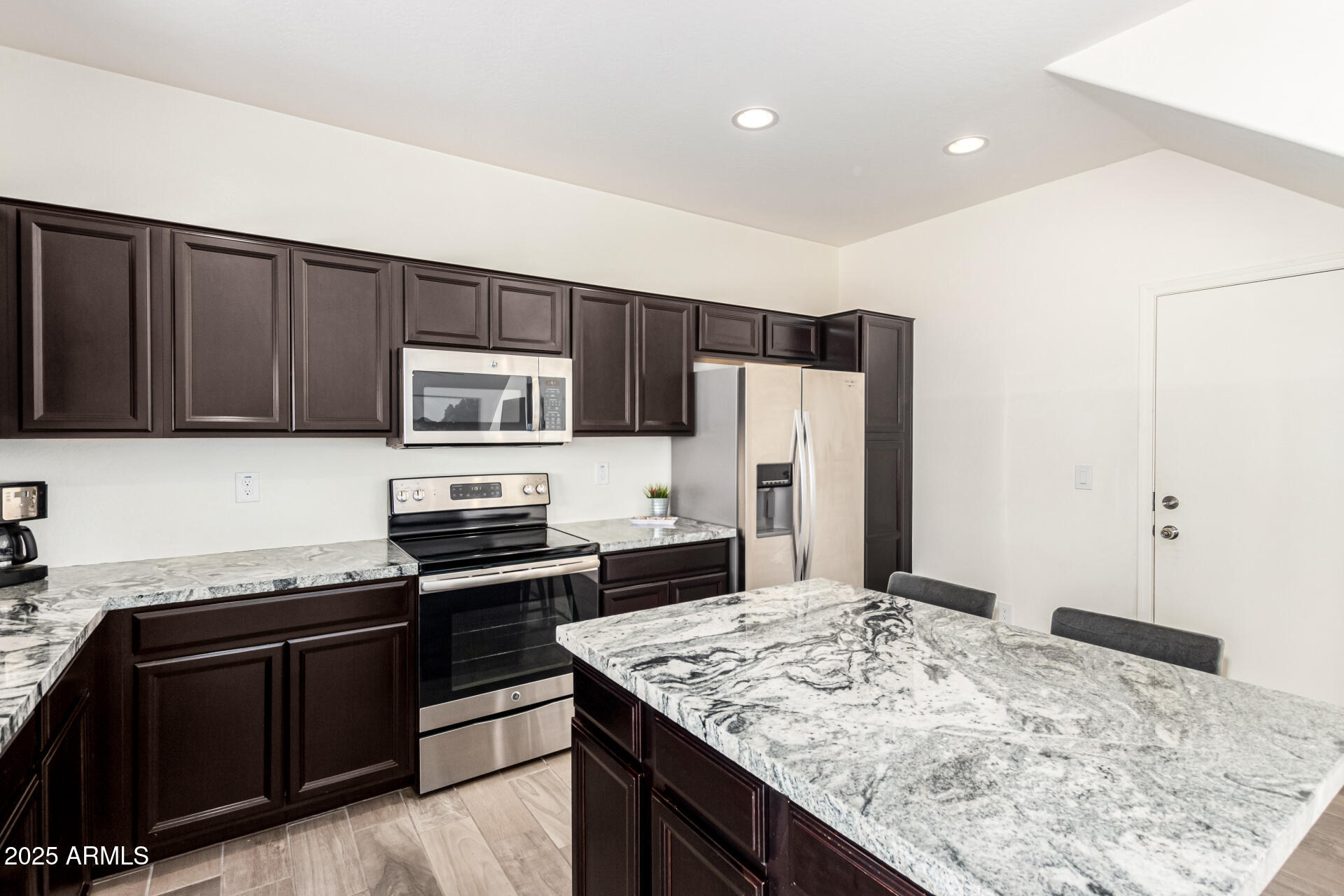820 Constance Way Phoenix, AZ 85042 - Photo 9 of 29 a kitchen with stainless steel appliances granite countertop a sink stove and refrigerator