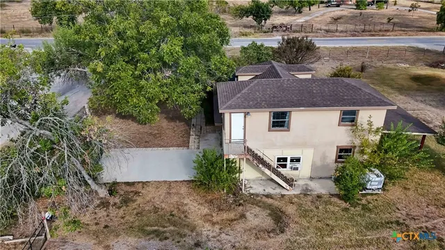 an aerial view of a house with garden space and street view