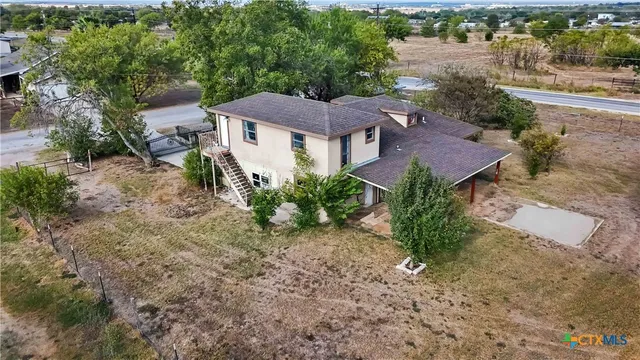 an aerial view of a house with a yard