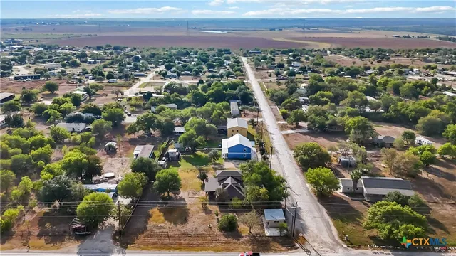 an aerial view of a house with a yard and lake view