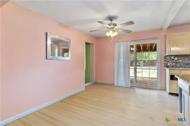 a view of empty room with window and fireplace