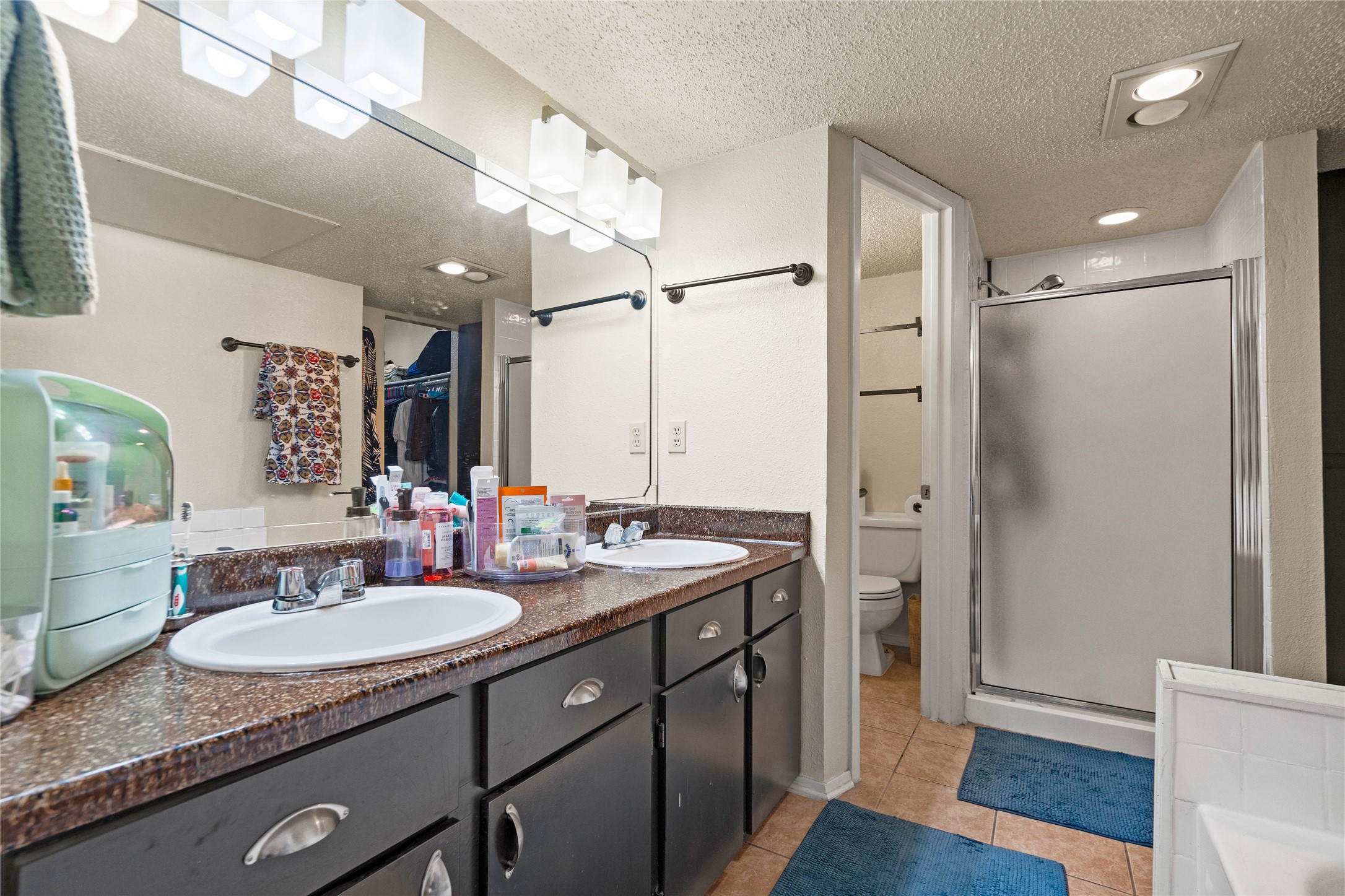 2018 West Rundberg Lane, Unit 4B Austin, TX 78758 - Photo 18 of 28 a bathroom with a granite countertop sink shower and a mirror
