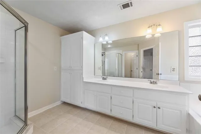 a bathroom with a sink vanity and mirror