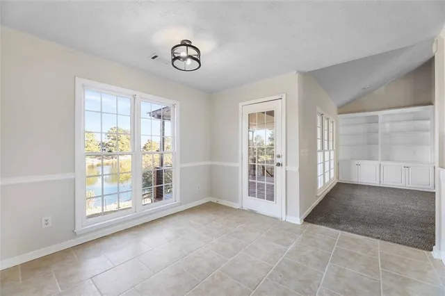 a kitchen with kitchen island granite countertop a stove top oven a sink and a refrigerator