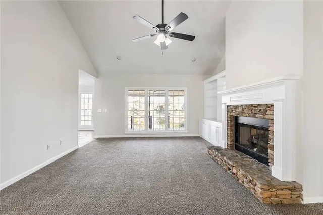 a view of a big house with a big yard and large tree