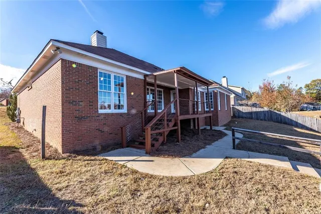 a front view of a house with wooden fence