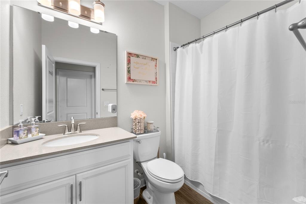 2926 Wordsmith Road Kissimmee, FL 34746 - Photo 36 of 42 a bathroom with a granite countertop sink and a mirror