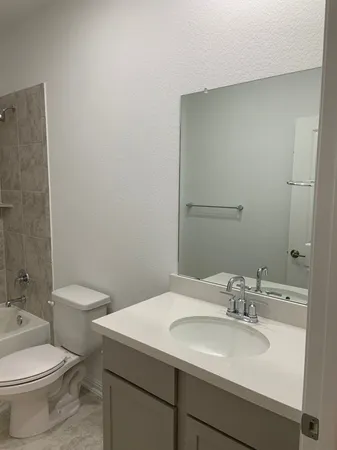 a bathroom with a toilet a sink and a bathtub