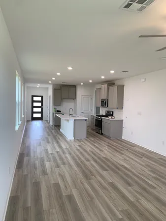 a view of kitchen dining table chairs microwave and cabinets