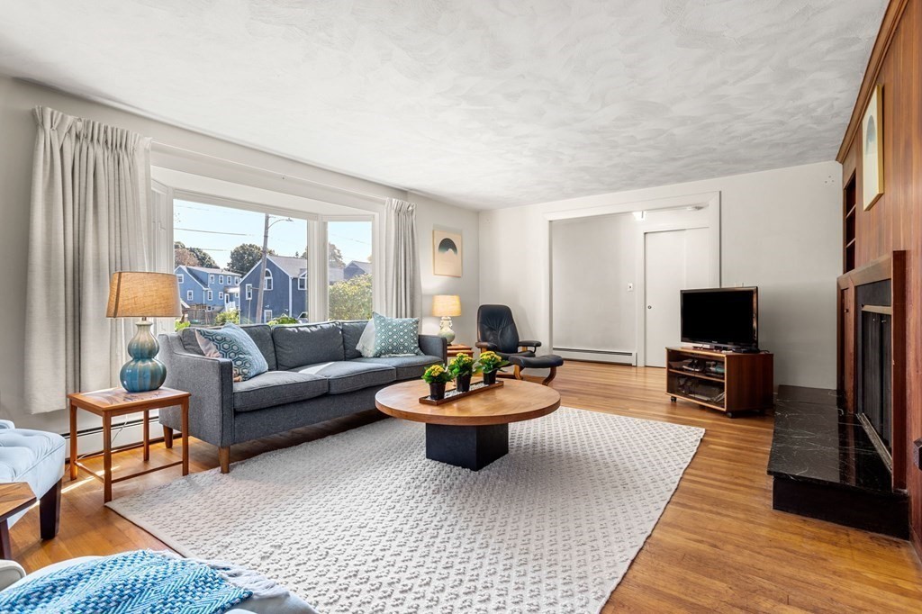 7 Hawthorn Road Marblehead, MA 01945 - Photo 4 of 24 a living room with furniture a flat screen tv and a large window