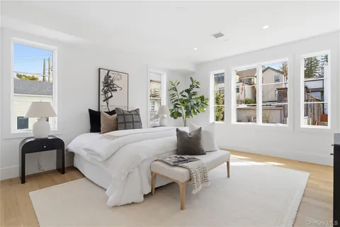 a bedroom with a bed and a potted plant